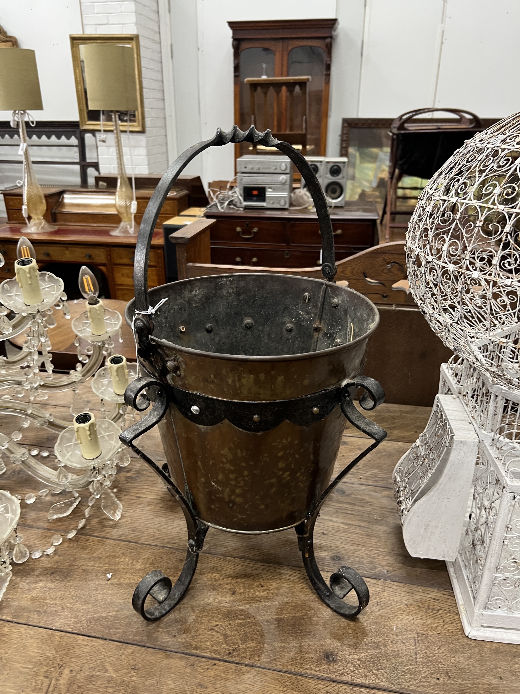 An early 20th century copper and wrought iron coal bucket, height 60cm, together with a wirework birdcage
